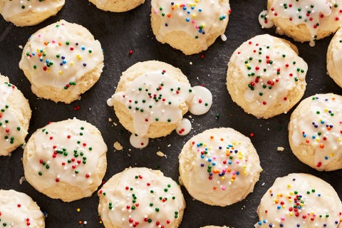 italian ricotta cookies topped with icing glaze and non pareil sprinkles