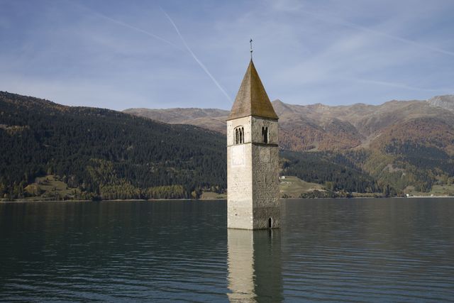 italy, val venosta, malles, curon, church tower in middle of lake