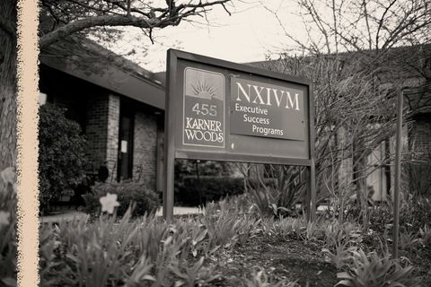 a sign reading nxivm at the organization's headquarters in albany new york