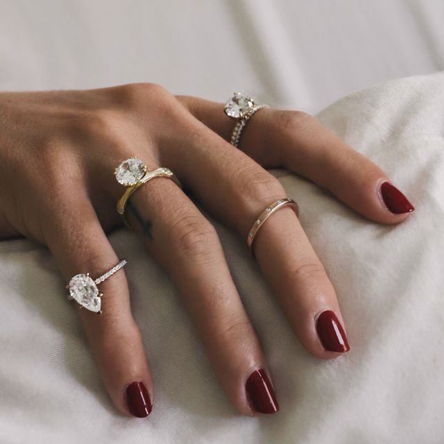 two hands wearing rings