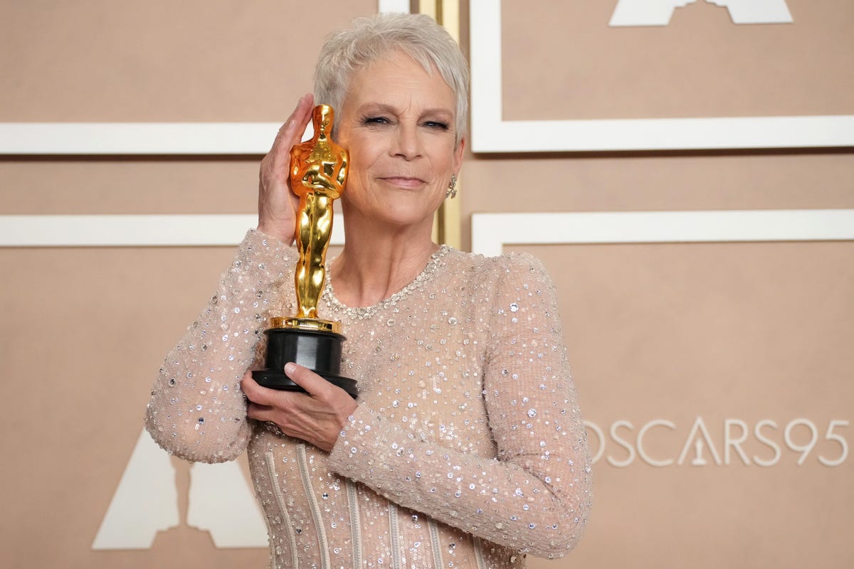 What curious object accompanies Jamie Lee Curtis’s Oscar on her altar?