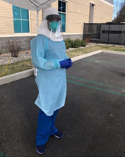 dr jehanne julien banica stands in ppe waiting to test covid 19 patients