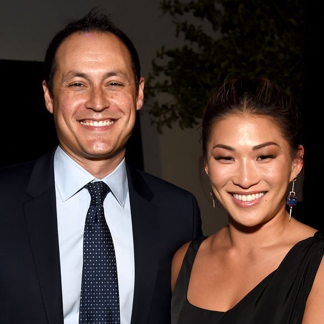 jenna ushkowitz and david stanley smile as they are photographed together at a red carpet event