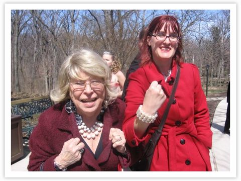 jennifer billock and mother in red coats showing off their pearl jewelery