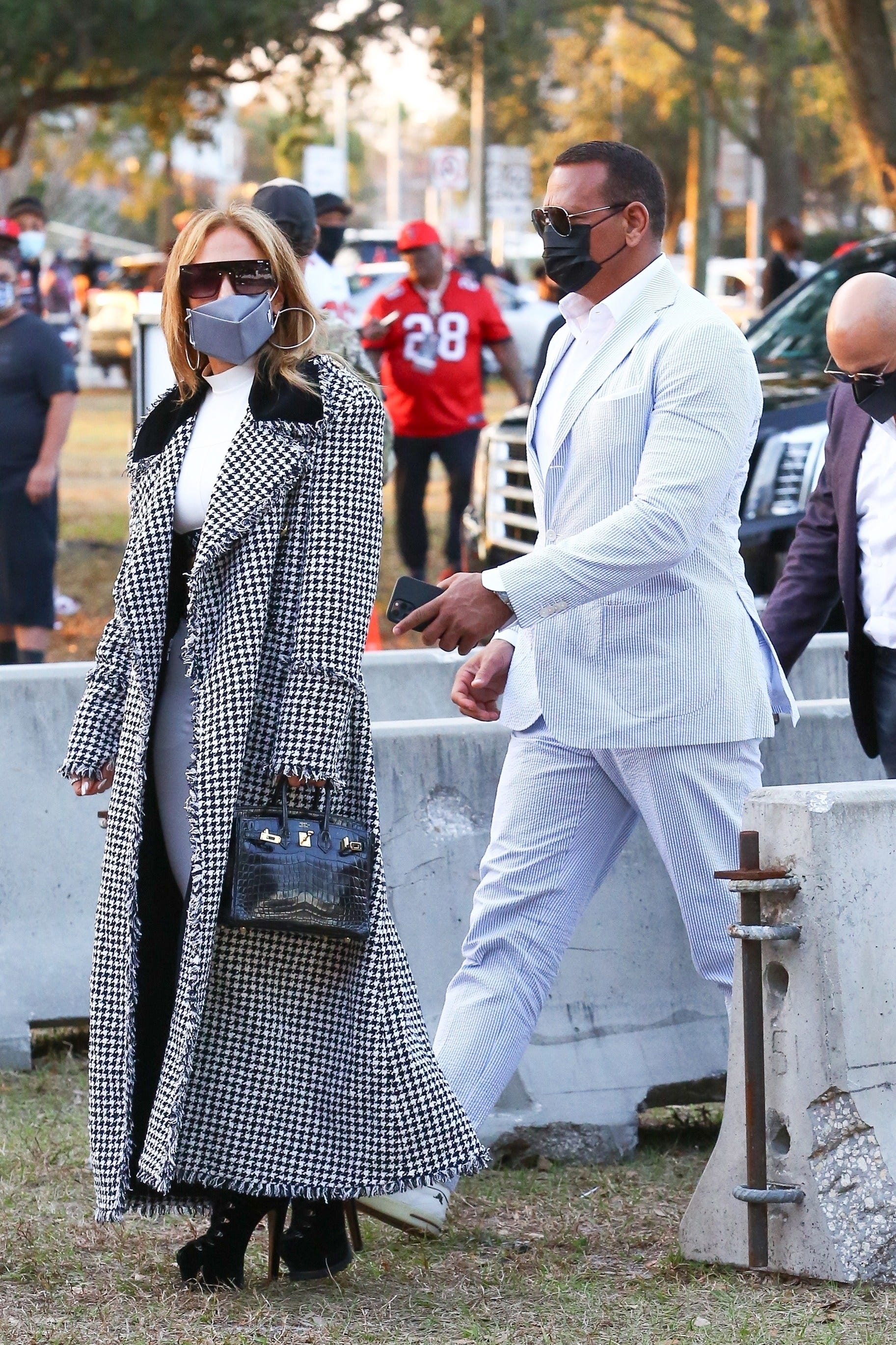 Jennifer Lopez Wore an Ab-Baring Louis Vuitton Crop Top and Long Houndstooth Coat to the Super Bowl