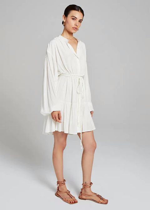 jennifer lopez luce un look de vestido blanco tipo túnica que combina con sus botas altas de plataforma favoritas de siempre con estética country