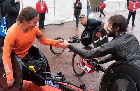 nikita den boer ned women’s winner being congratulated by brent lakatos can mens winner at the finish of the elite wheelchair race the historic elite only virgin money london marathon taking place on a closed loop circuit around st jamess park in central london on sunday 4 october 2020photo jed leicester for virgin money london marathon for further information medialondonmarathoneventscouk