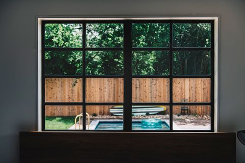 backyard pool through modern window