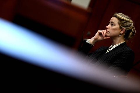 topshot us actress amber heard looks on in the courtroom at the fairfax county circuit courthouse in fairfax, virginia, on may 17, 2022 us actor johnny depp is suing ex wife amber heard for libel after she wrote an op ed piece in the washington post in 2018 referring to herself as a public figure representing domestic abuse photo by brendan smialowski pool afp photo by brendan smialowskipoolafp via getty images