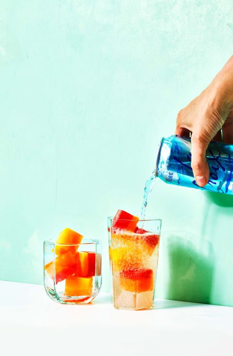 vodka soda with fruity ice cubes in glasses