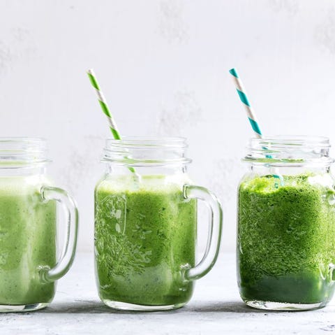 Variety of three color green spinach kale apple yogurt smoothie in mason jars in row with retro cocktail tubes over gray background. Healthy vegan detox eating. variety of three color green spinach kale apple yogurt smoothie in mason jars in row with retro cocktail tubes over gray background healthy vegan detox eating photo by natasha breenredacouniversal images group via getty images