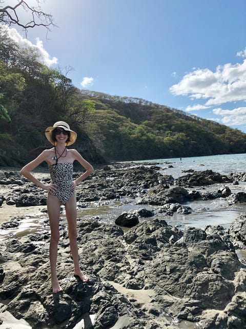 karen oelschlaeger standing on river rocks in leopard print bikini