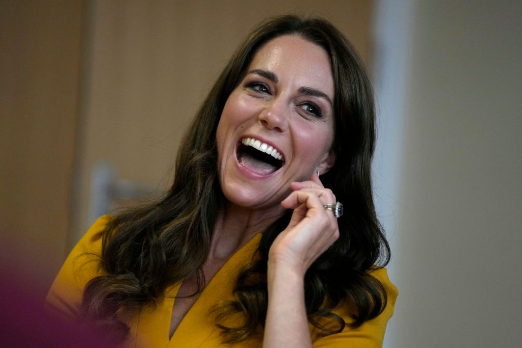 Kate Middleton Holds A Baby During A Visit To A Hospital