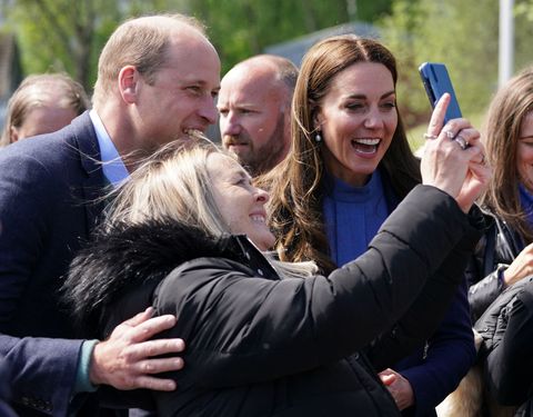 kate middleton and prince william taking a selfie with a fan