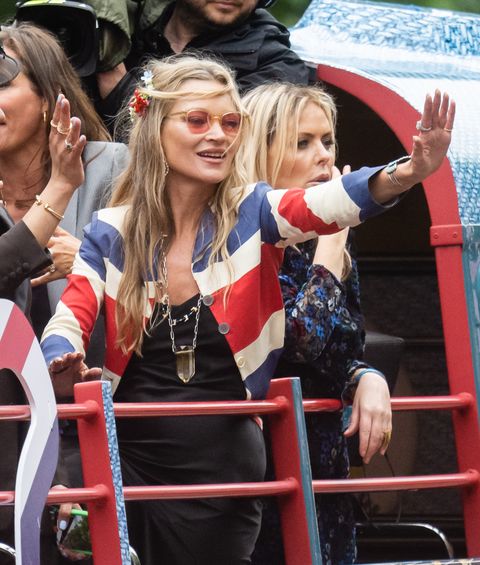 Kate Moss greets the crowd during the parade