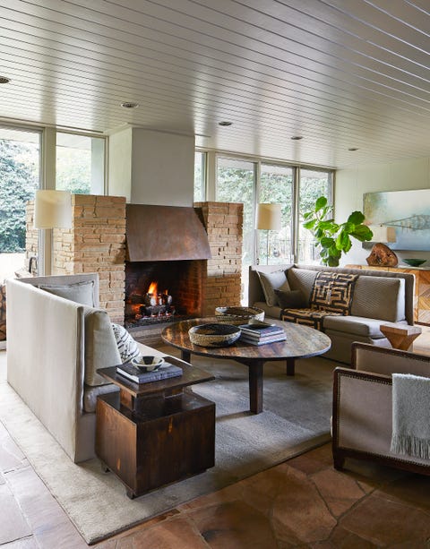 a stone and copper hearth warms a sitting room