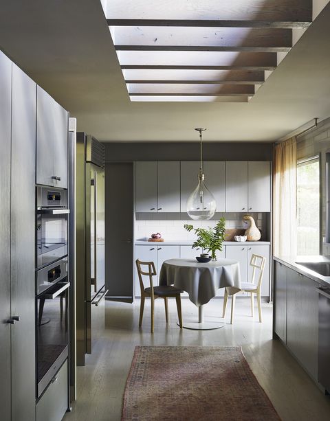 cleanup is reserved for a large working pantry behind a glass and vinyl pivot door