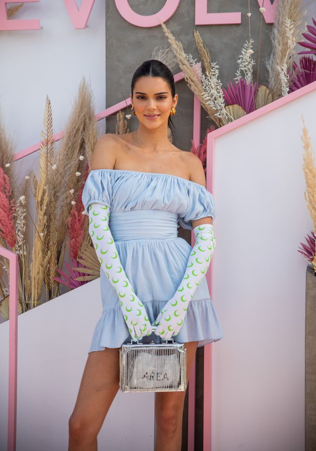 la quinta, california   april 14 kendall jenner is seen wearing blue off shoulder dress, gloves with print at revolve festival during coachella festival on april 14, 2019 in la quinta, california photo by christian vieriggetty images