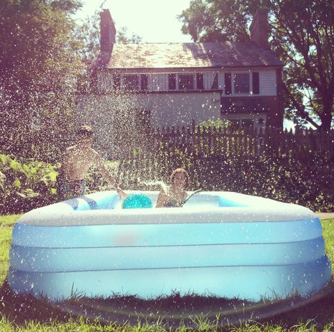 kids playing with hose and swimming pool