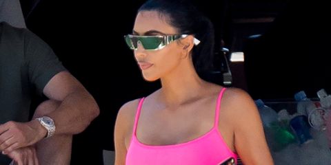 Kim Kardashian shows off her famous curves in vintage hot pink Chanel onesie during Miami boat trip
