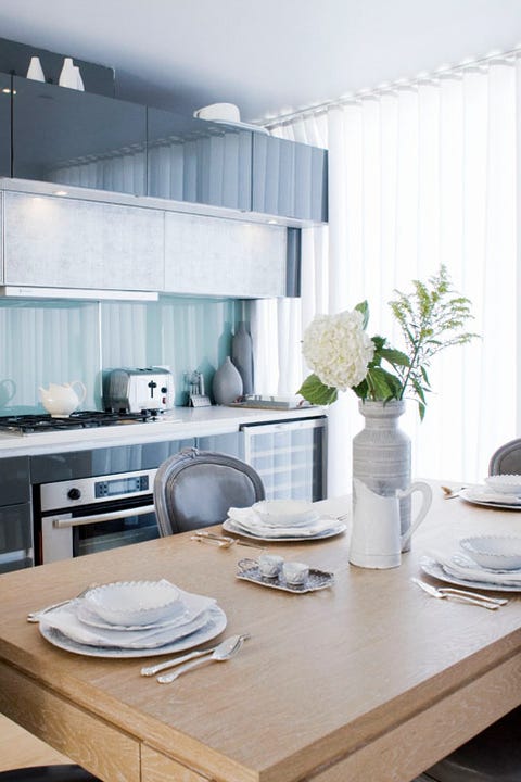 kitchen with blue backsplash and curtains