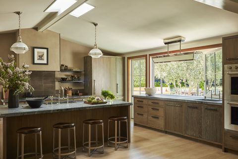 1970's cottage in napa in the kitchen, cerused white oak cabinetry, brazilian soapstone counters, and bronze hardware rocky mountain hardware