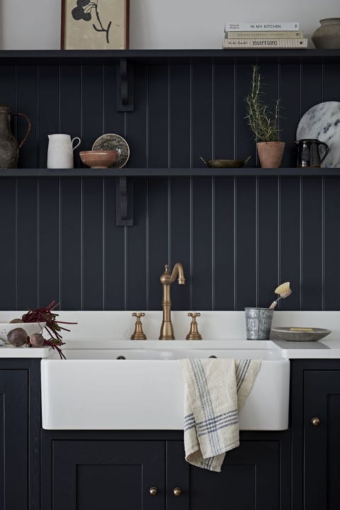 navy kitchen with small shelf above