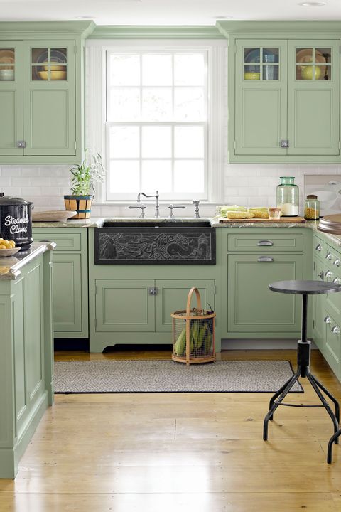 light green kitchen cabinets with white subway tile backsplash