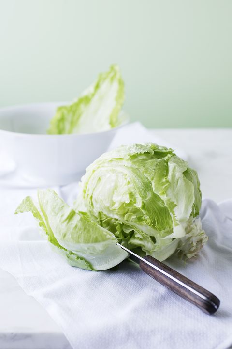 Knife slicing through head of lettuce