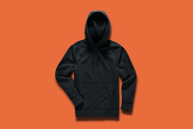 a black hoodie on an orange background