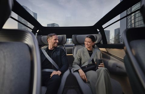 a man and a woman sit in the back of the audi urbansphere concept car