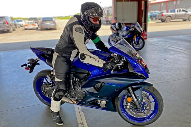 man sitting on a blue yamaha yzf motorcycle