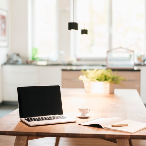 laptop and notebook on table at home