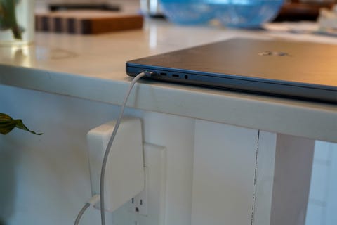 a laptop being charged on a counter