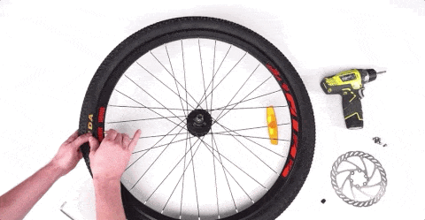man uses circular saws to replace traditional bike tires