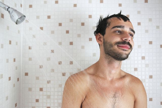 latin guy in shower, smiling