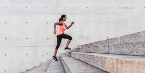 latina sports woman running up outdoor stairway in berlin