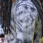 a man wearing a black and white tie dye wool shirt
