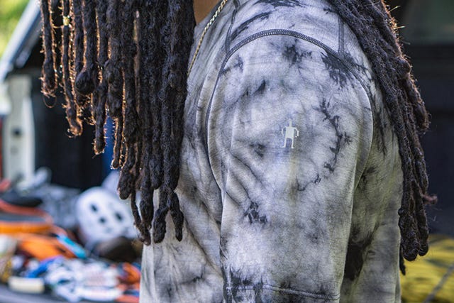 a man wearing a black and white tie dye wool shirt
