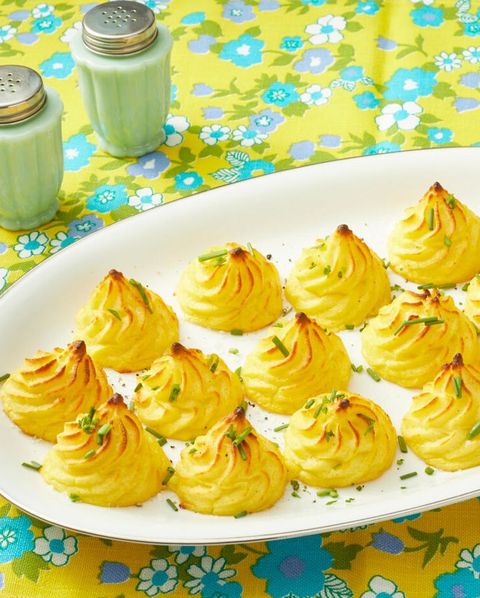 duchess potatoes on white platter yellow and blue background
