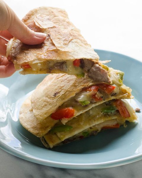 leftover steak recipes cheesesteak quesadillas stacked on blue plate