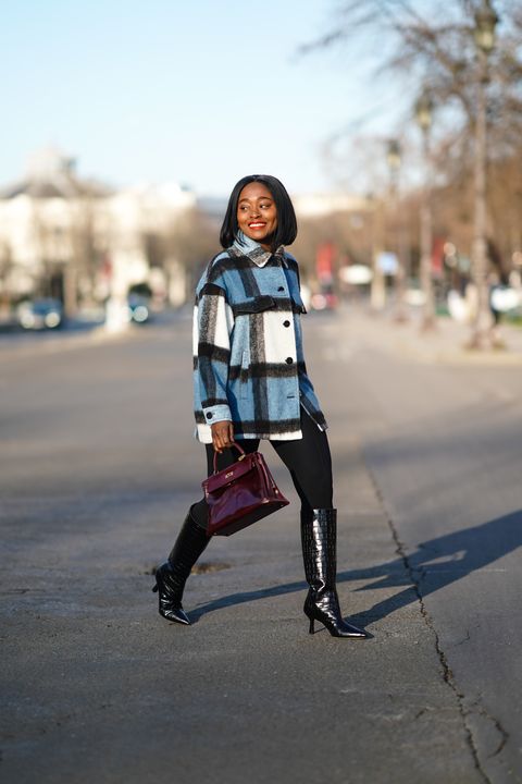 paris, france   january 09 carrole sagba aka linaose wears a blue and white checked wool jacket from zara, a purple  burgundy leather hermes birkin bag, black leggingspants from acne studios, black pointy high heeled knee high leather boots with printed crocodile patterns from dear frances, on january 09, 2021 in paris, france photo by edward berthelotgetty images