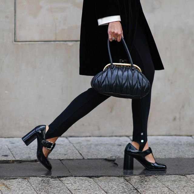 paris, france   october 06 a guest wears a black dress, black pants, black shiny shoes, a miu miu leather bag, outside miu miu, during paris fashion week   womenswear spring summer 2021, on october 06, 2020 in paris, france photo by edward berthelotgetty images