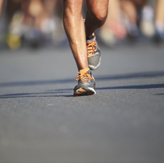legs and feet of joggers running a marathon