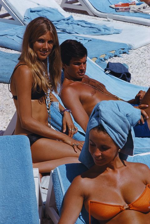 american actor george hamilton relaxes on a deckchair in capri, 1968 with him left is his future wife, alana collins, aka alana hamilton, aka alana stewart photo by slim aaronshulton archivegetty images
