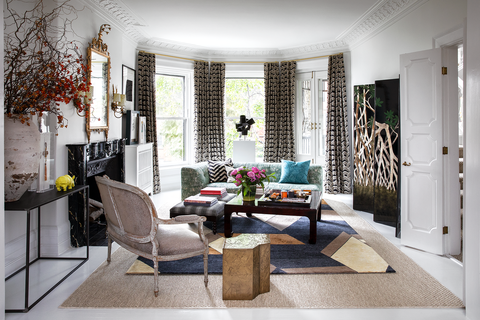 Modern living room with geometric rug and window alcove