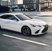 a white lexus driving on a highway