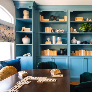 game room with built in shelving painted in light blue