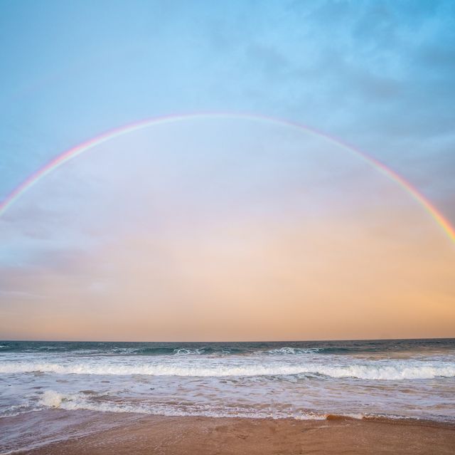 scenic view of rainbow over sea against sky