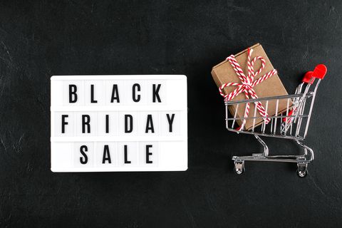 lightbox with text black friday sale, grocery cart with gift present on dark background